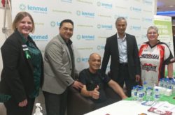 Patient giving thumbs up with doctors alongside him