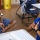 African american female teacher and a girl talking in hand sign language