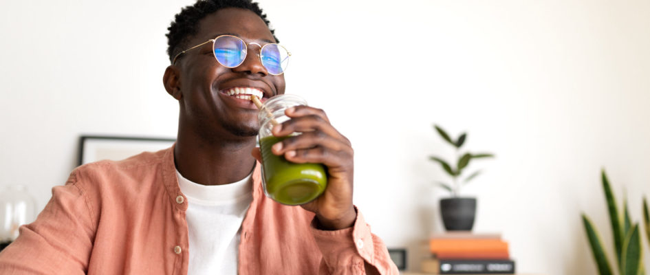 african-american-man-drinks-green-juice-with-bambo-2022-08-10-20-05-16-utc