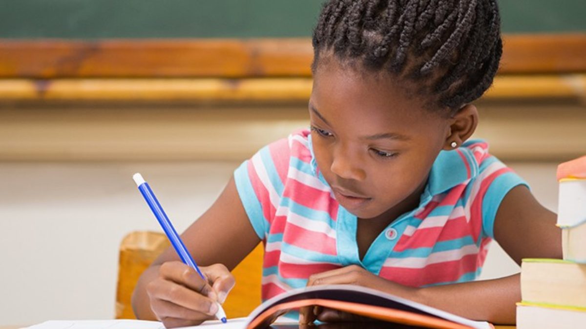 girl child writing in her book