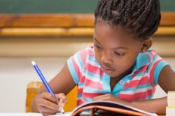 girl child writing in her book