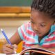 girl child writing in her book