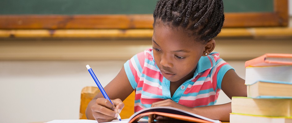 girl child writing in her book