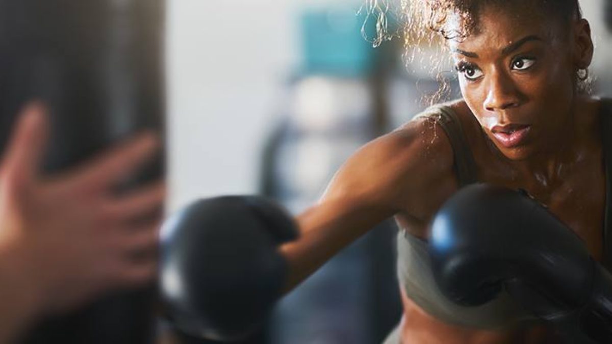 African woman punching a punch bag