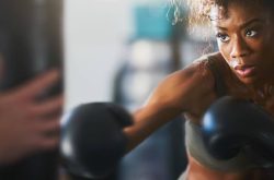 African woman punching a punch bag