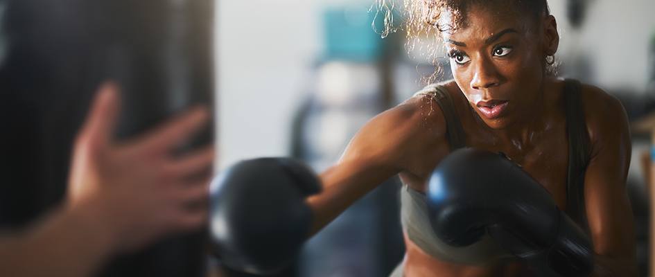 African woman punching a punch bag