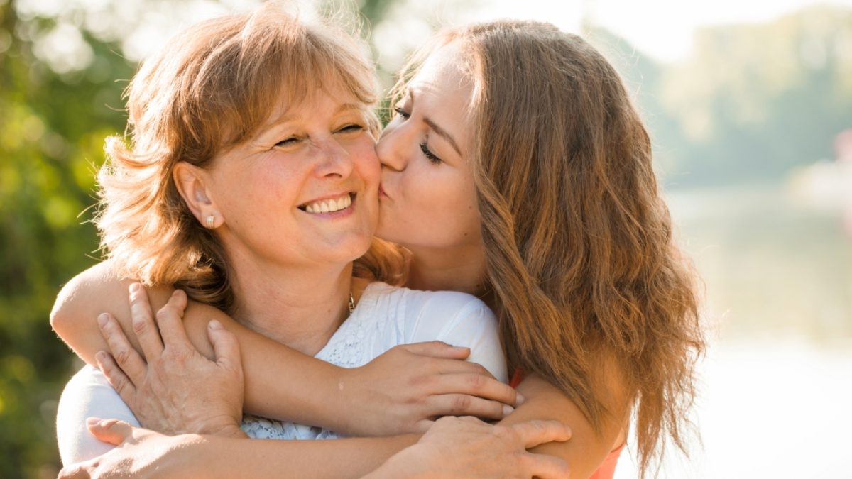 daughter kissing mother on cheek