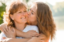 daughter kissing mother on cheek