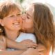 daughter kissing mother on cheek