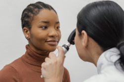 close up doctor checking patient eye