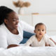 African American woman playing with her adorable black baby