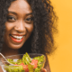 woman eating from a salad bowl