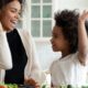 mother and daughter high-fiving in the kitchen