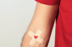 cross band-aid on an arm