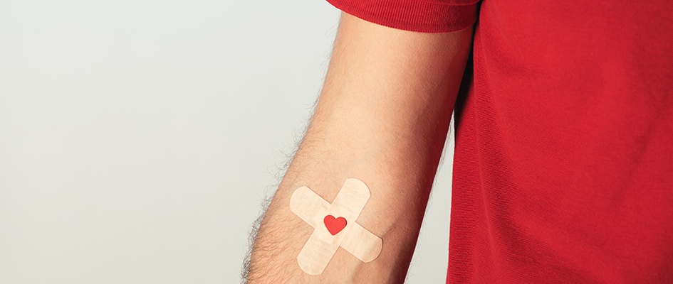 cross band-aid on an arm