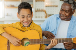 African America grandfather sitting at home with his grandson.