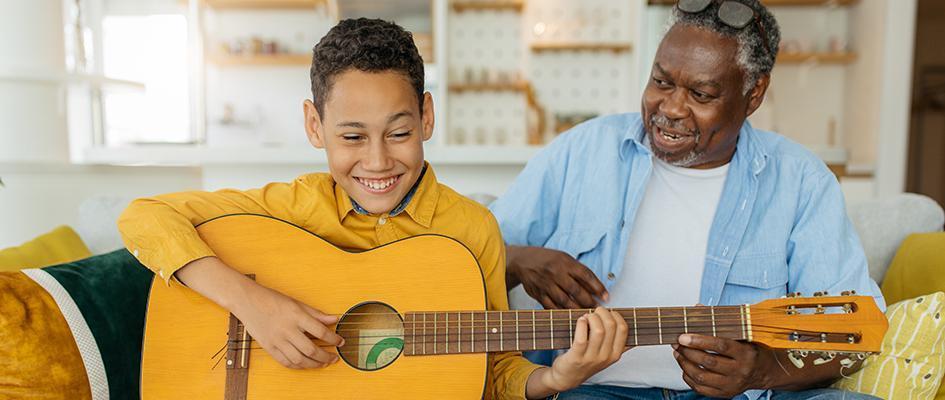 African America grandfather sitting at home with his grandson.