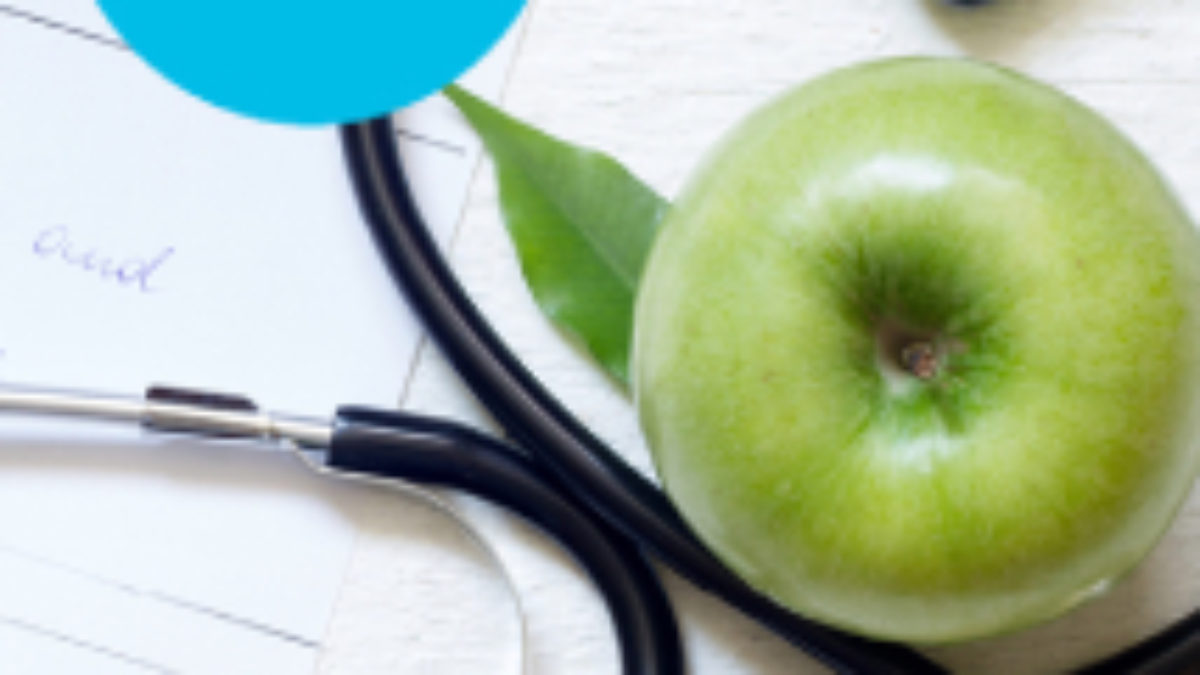 high blood pressure cover with sethescope and an apple as a background