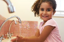 child hand washing by the tap