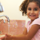 child hand washing by the tap
