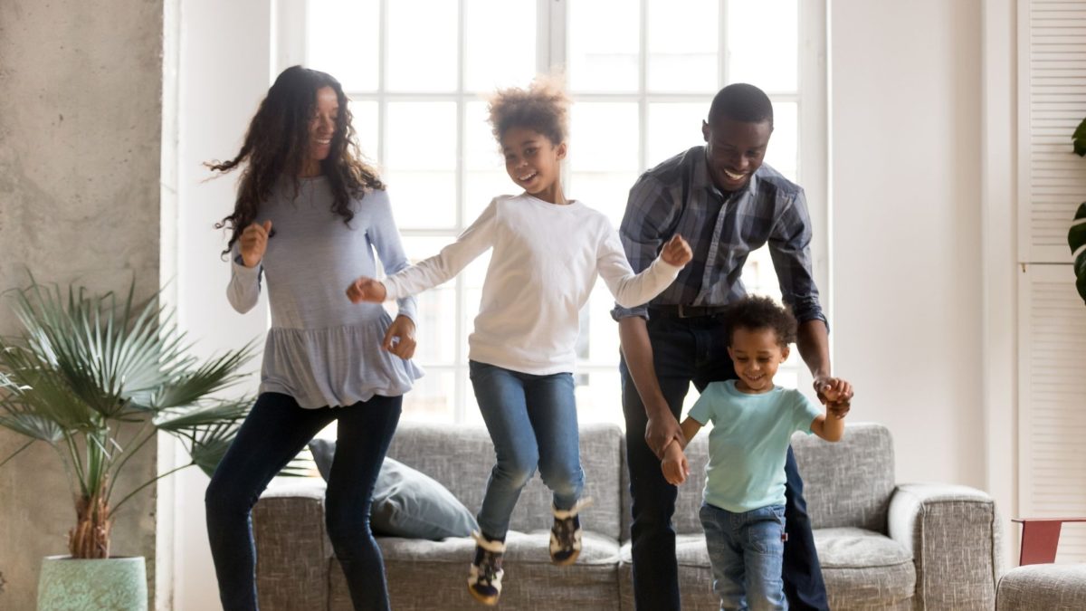African family dancing in their living room