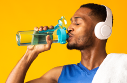 man with headphones on drinking water