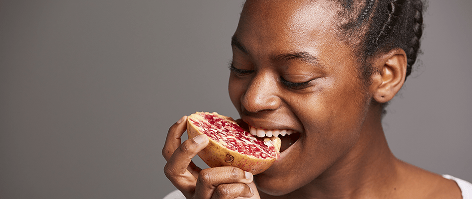 woman eating pomegranate