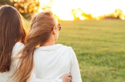 couple hugging and watching sunset