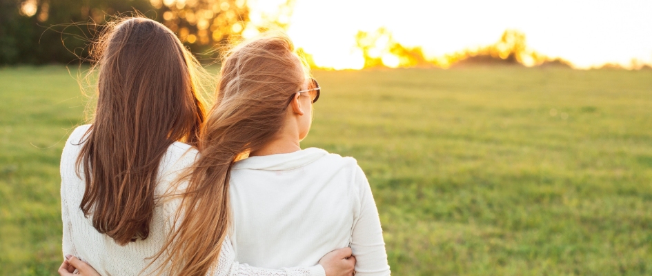 couple hugging and watching sunset