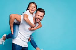 Dad playing with daughter on her back