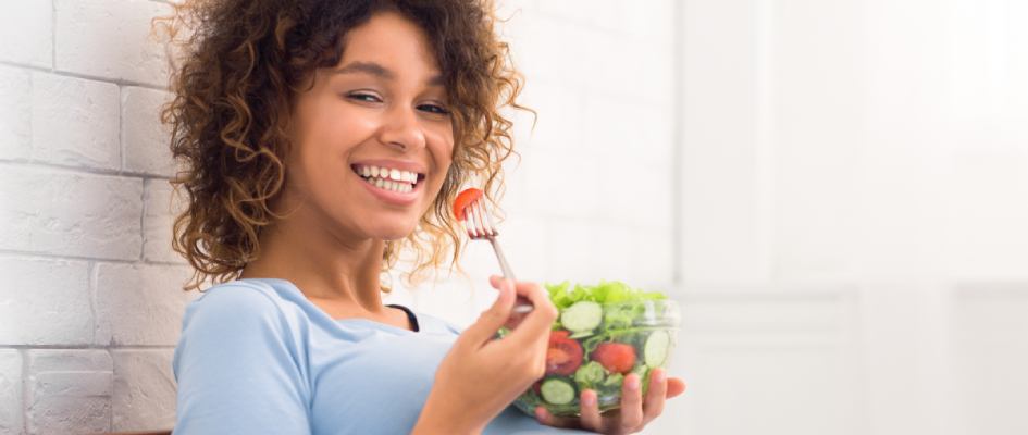 women eating tomato from salad bowl