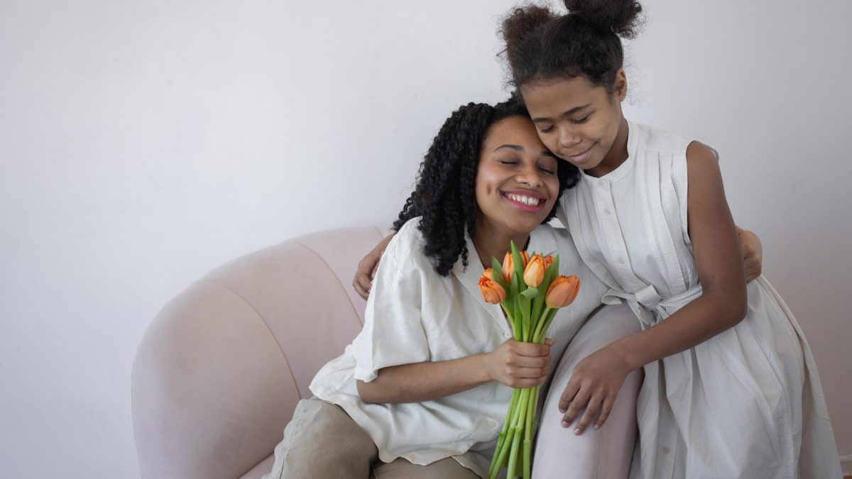 mother and girl child hugging