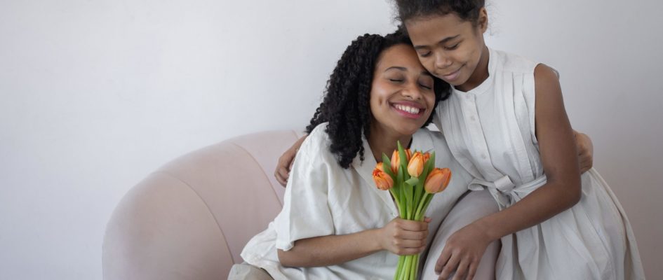 mother and girl child hugging