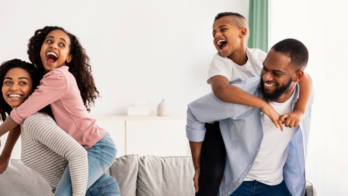 Portrait of a happy black family having fun at home