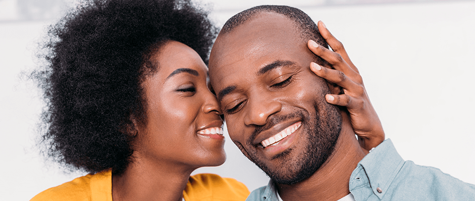 woman holding her partner's face against hers