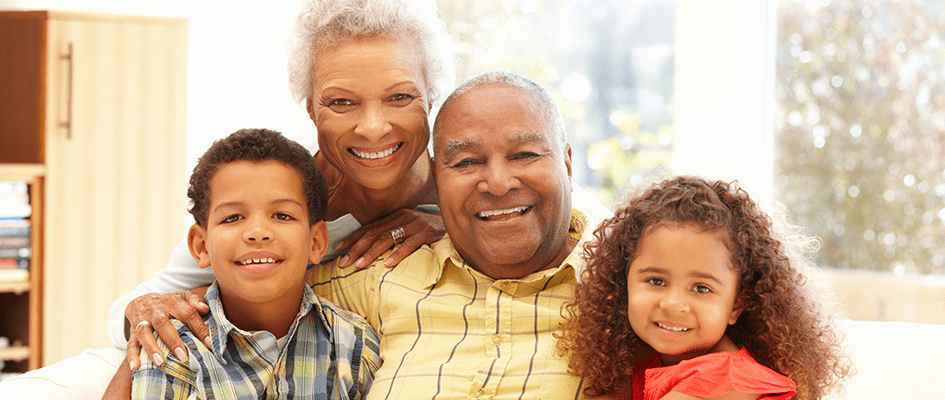 grandparents smiling with their grandchildren