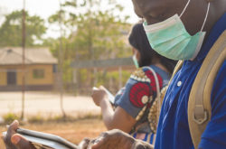 black people, travellers, wearing face masks, standing outdoors