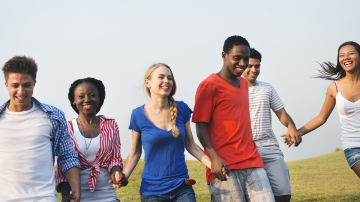 students laughing and hold hands