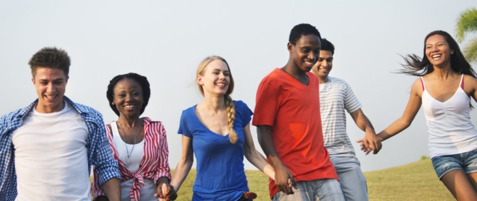 students laughing and hold hands