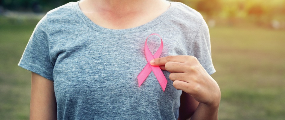 women holding cancer ribbon on left side of the chest