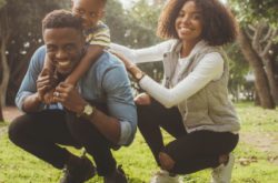 family playing together on the grass