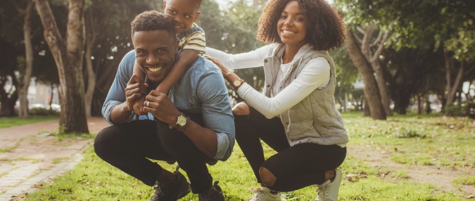 family playing together on the grass