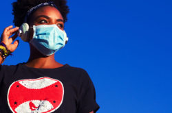 Young black woman with black power hair wearing protective mask