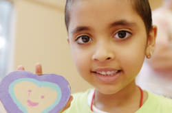 child showing heart-shaped cookie