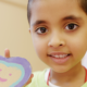 child showing heart-shaped cookie