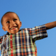 Happy Child smiling with arms in the air