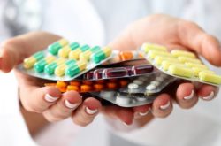 assorted pills in doctor's hands