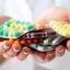 assorted pills in doctor's hands