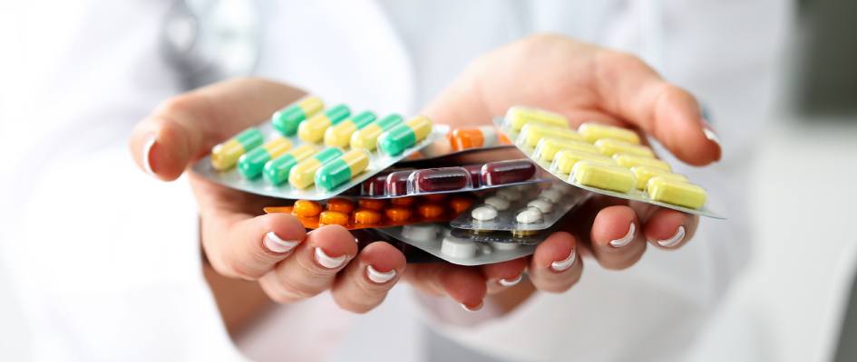 assorted pills in doctor's hands