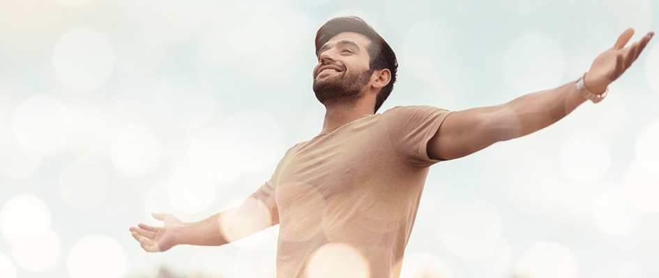 happy man with arms open wide